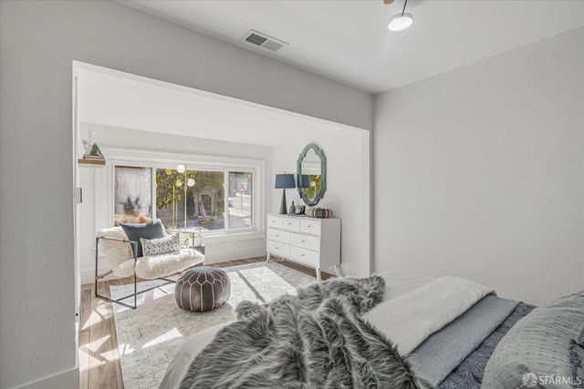 a bedroom with a bed and a couch