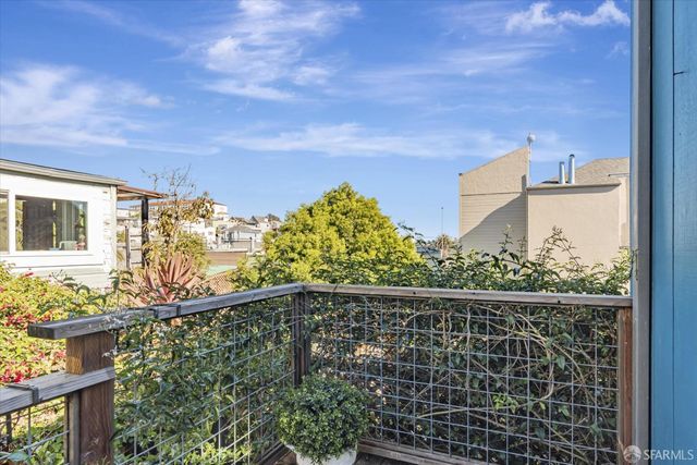 a view of a balcony with wooden fence and floor