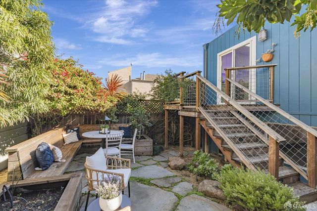 a view of a patio with iron fence