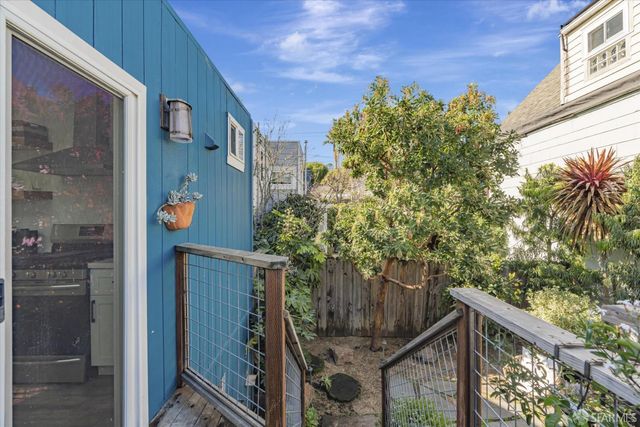 a view of a house with a tree in front of it