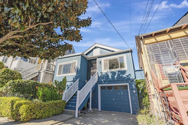 a front view of a house with a garden