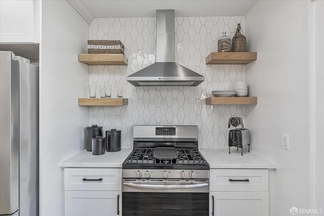 a stove top oven sitting inside of a kitchen