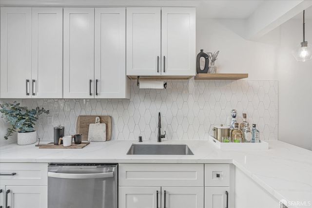 a kitchen with white cabinets and a sink