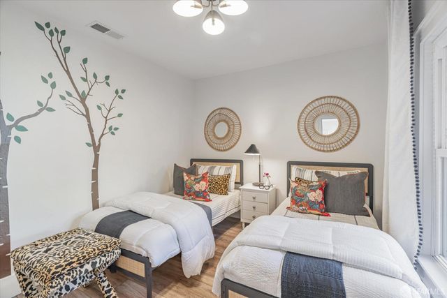 a bedroom with bed and a chandelier