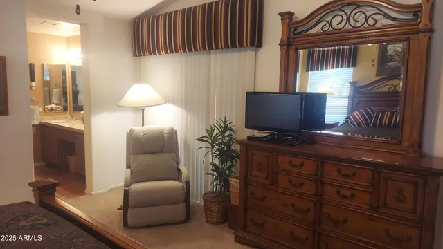 a living room with furniture and a lamp