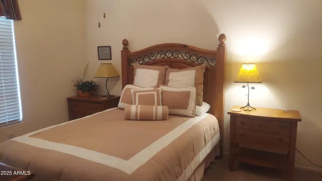 a bedroom with a bed and a lamp