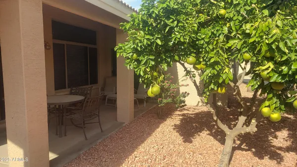 a backyard of a house with table and chairs
