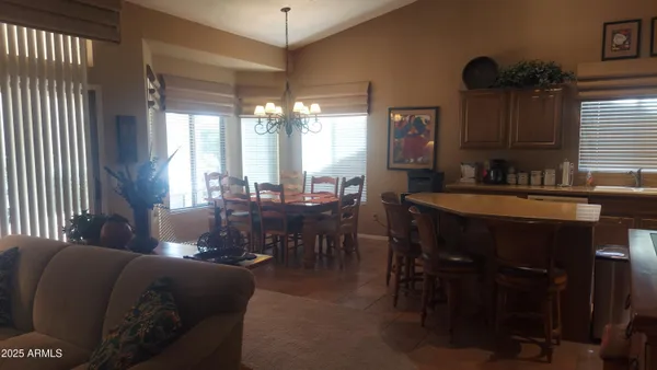 a view of a dining room with furniture and chandelier