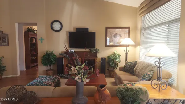 a living room with furniture a couch and a flat screen tv