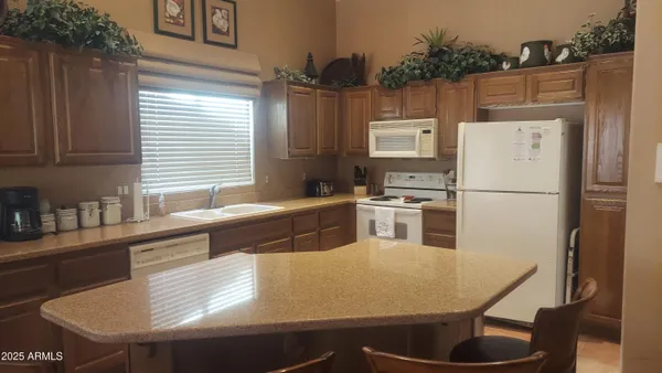 a kitchen with stainless steel appliances granite countertop a sink a refrigerator and a stove