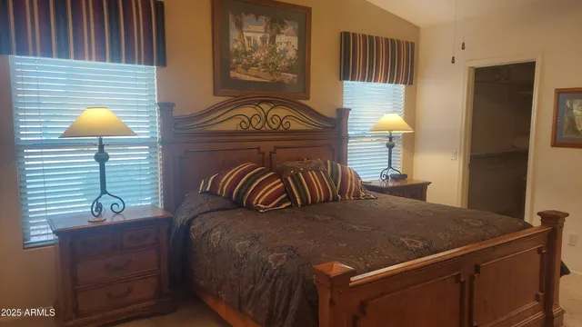 a view of a bedroom with a bed and chair