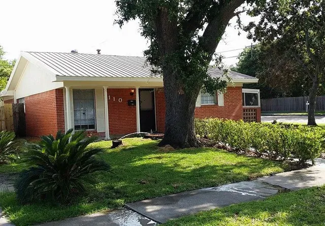 a view of house with a yard