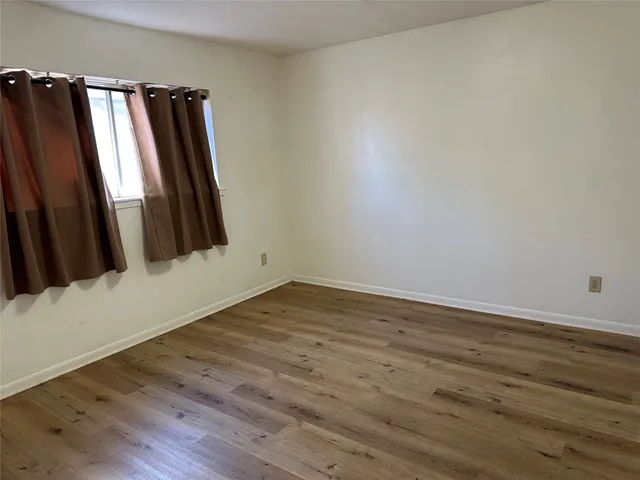 an empty room with wooden floor