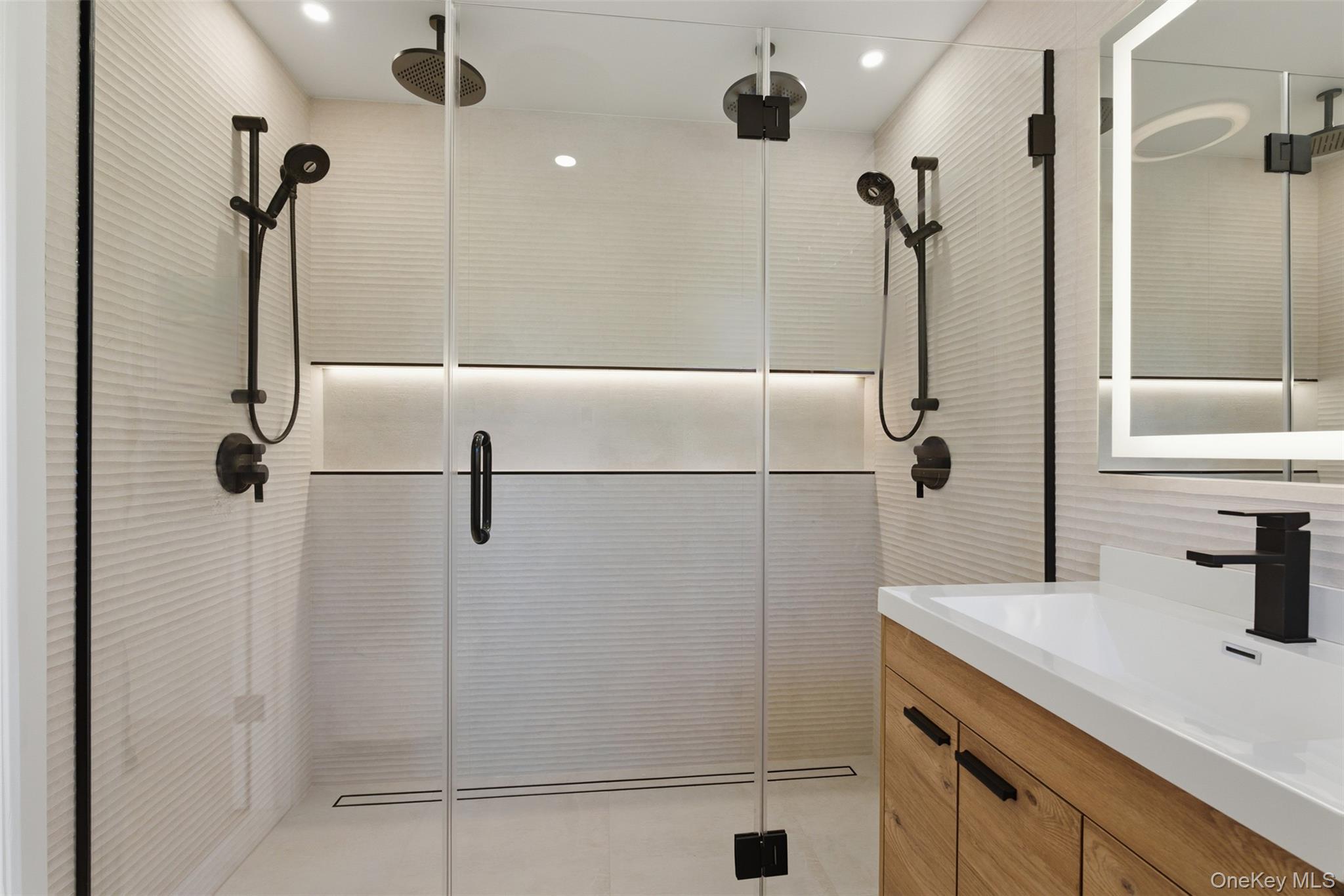 40 Calhoun Avenue New Rochelle, NY 10801 - Photo 24 of 49 Contemporary bathroom featuring a spacious shower with dual matte black shower heads and textured tile walls