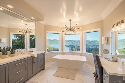 a spacious bathroom with a large tub and sink