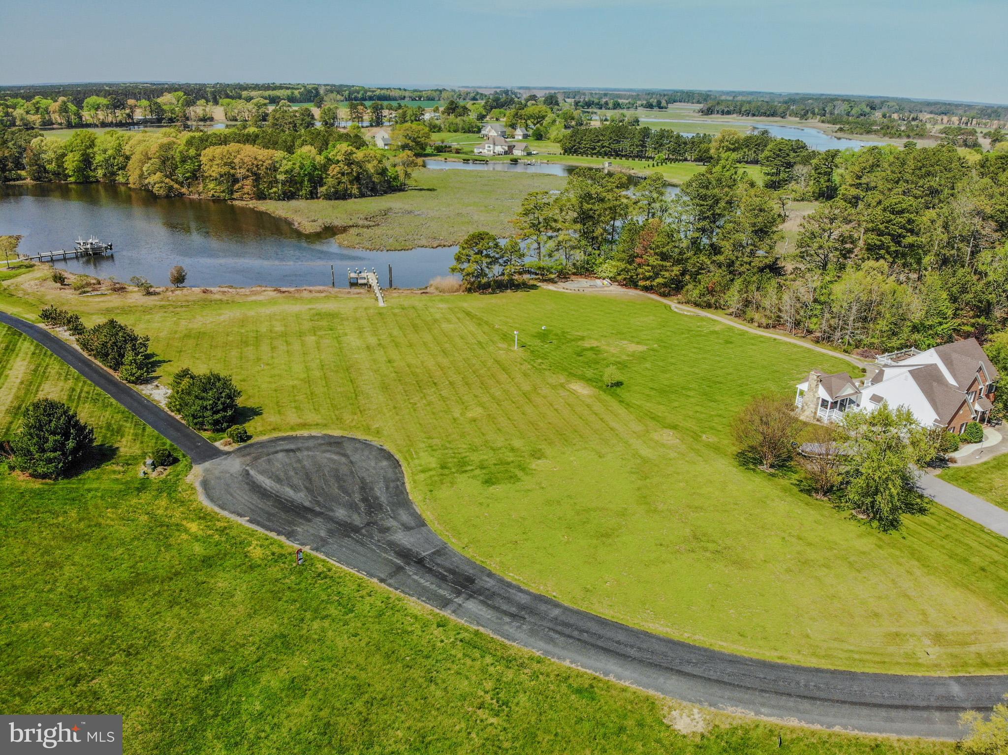 12480 Mallard Landing Road Princess Anne, MD 21853 - Photo 12 of 32 a view of a lake with a houses in the back