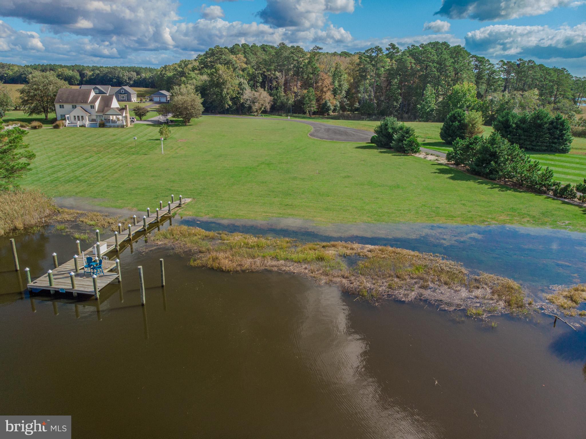 12480 Mallard Landing Road Princess Anne, MD 21853 - Photo 30 of 32 a view of a lake with a building in the background