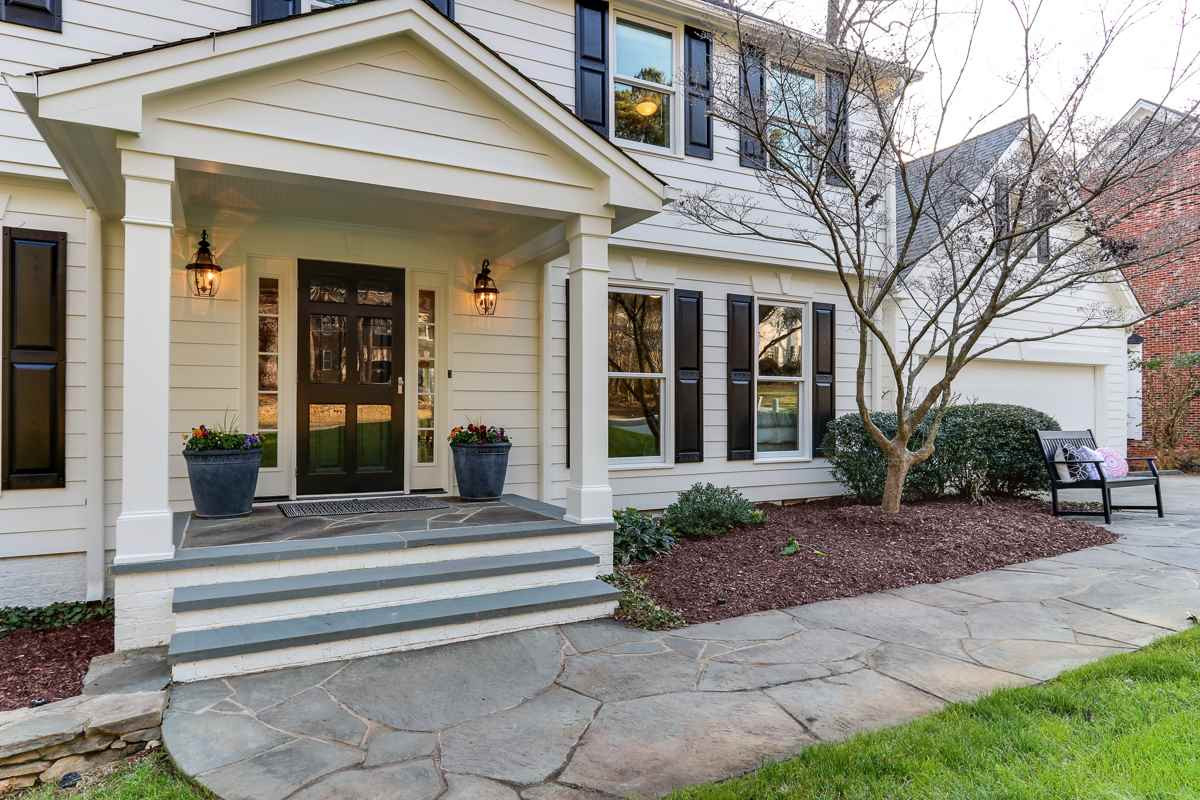 7009 North Ridge Drive Raleigh, NC 27615 - Photo 2 of 25 Welcoming covered entrance with flagstone sidewalk and porch Exterior Front