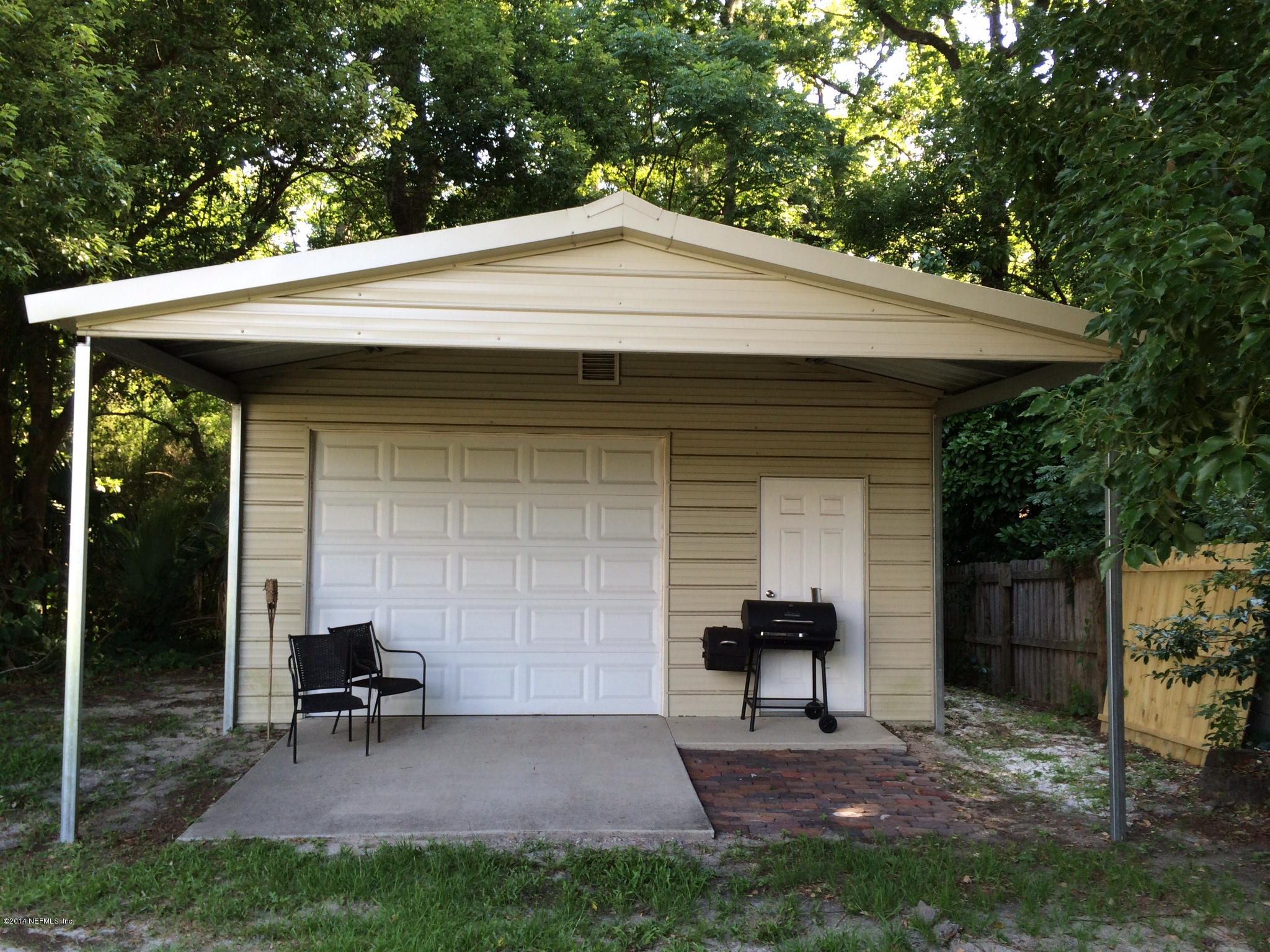 5114 Damascus Road South Jacksonville, FL 32207 - Photo 4 of 12 a backyard of a house with table and chairs