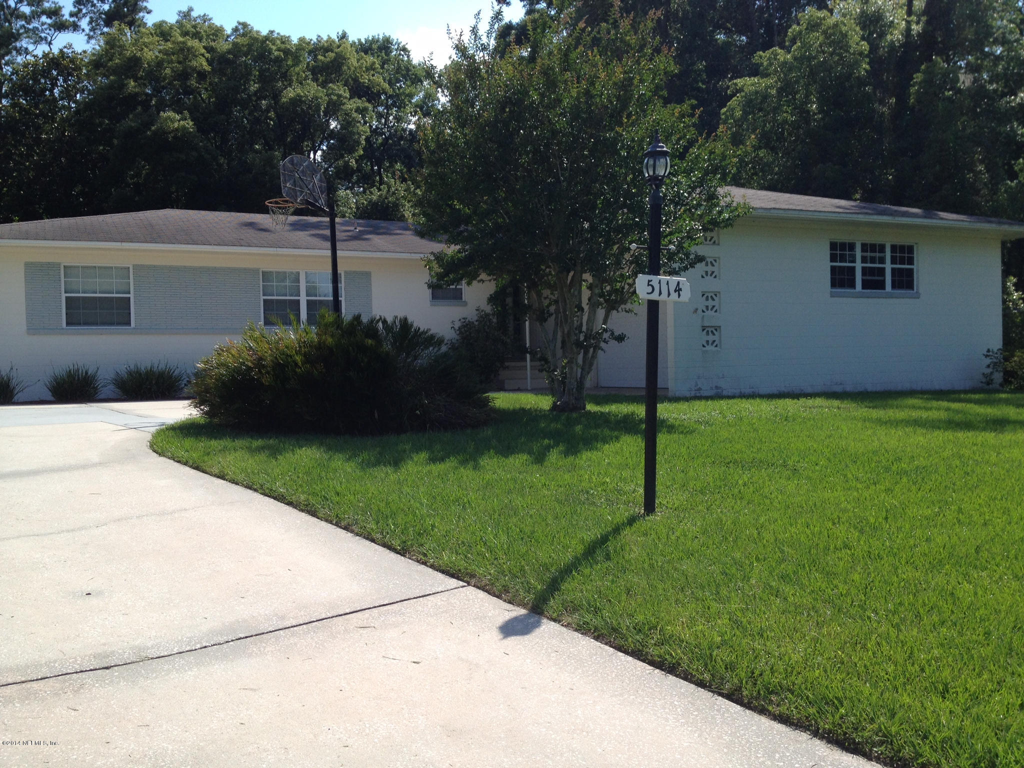 5114 Damascus Road South Jacksonville, FL 32207 - Photo 6 of 12 a front view of a house with a garden and yard