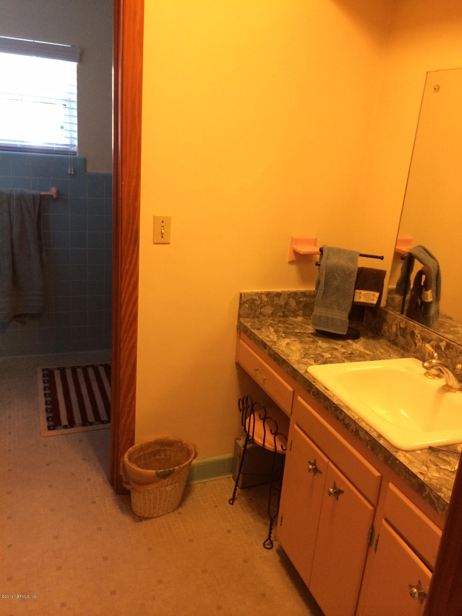 5114 Damascus Road South Jacksonville, FL 32207 - Photo 7 of 12 a bathroom with a sink and a mirror