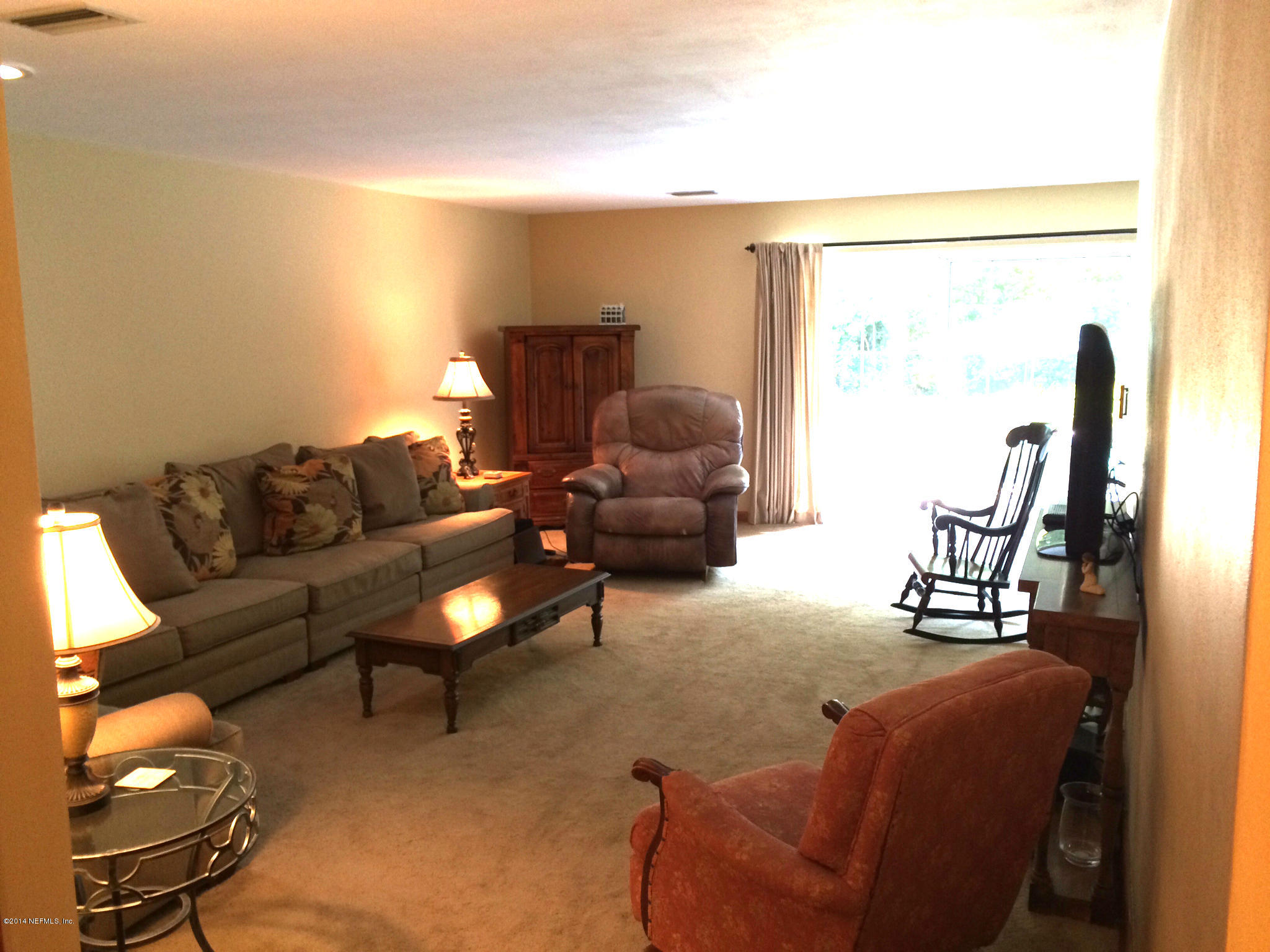 5114 Damascus Road South Jacksonville, FL 32207 - Photo 8 of 12 a living room with furniture and a flat screen tv