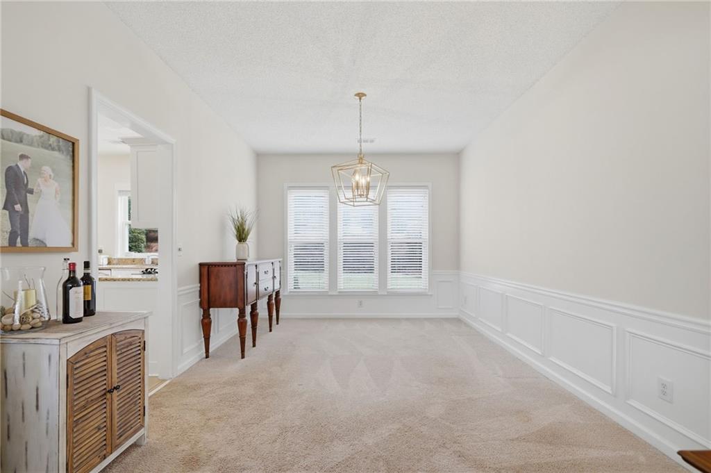 2135 Sugar Maple Lane Northwest Acworth, GA 30101 - Photo 13 of 59 a spacious bedroom with a bed and a chandelier