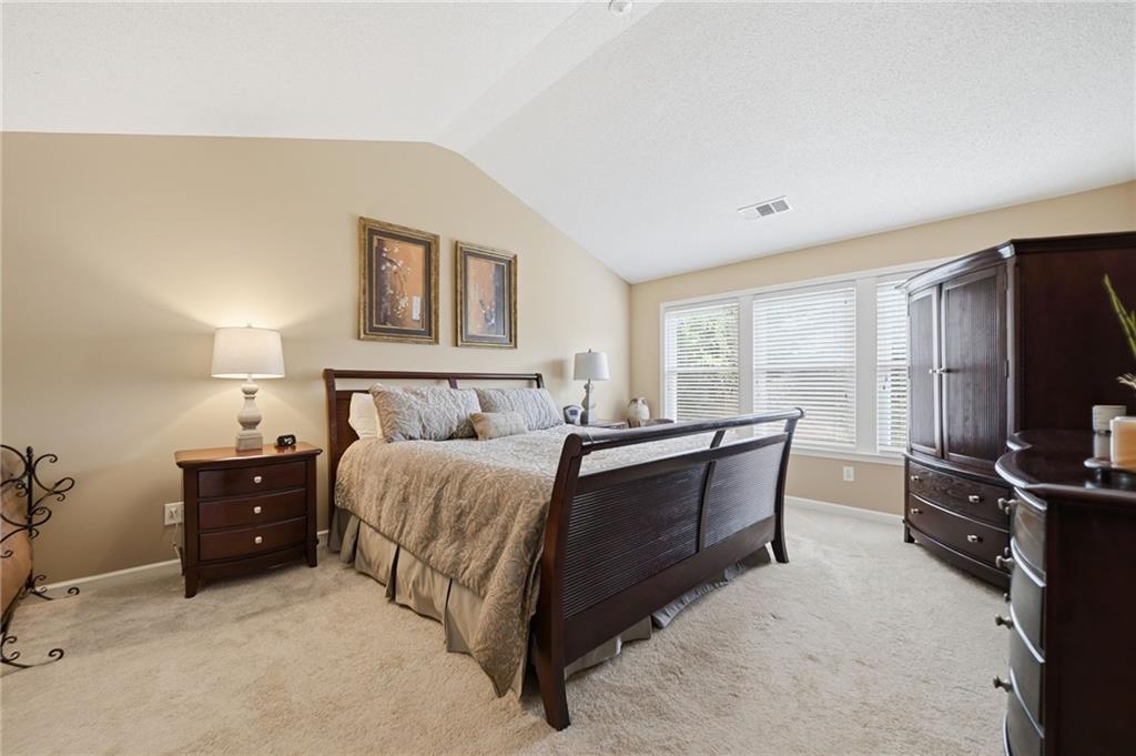 2135 Sugar Maple Lane Northwest Acworth, GA 30101 - Photo 30 of 59 a bedroom with a bed and a flat screen tv