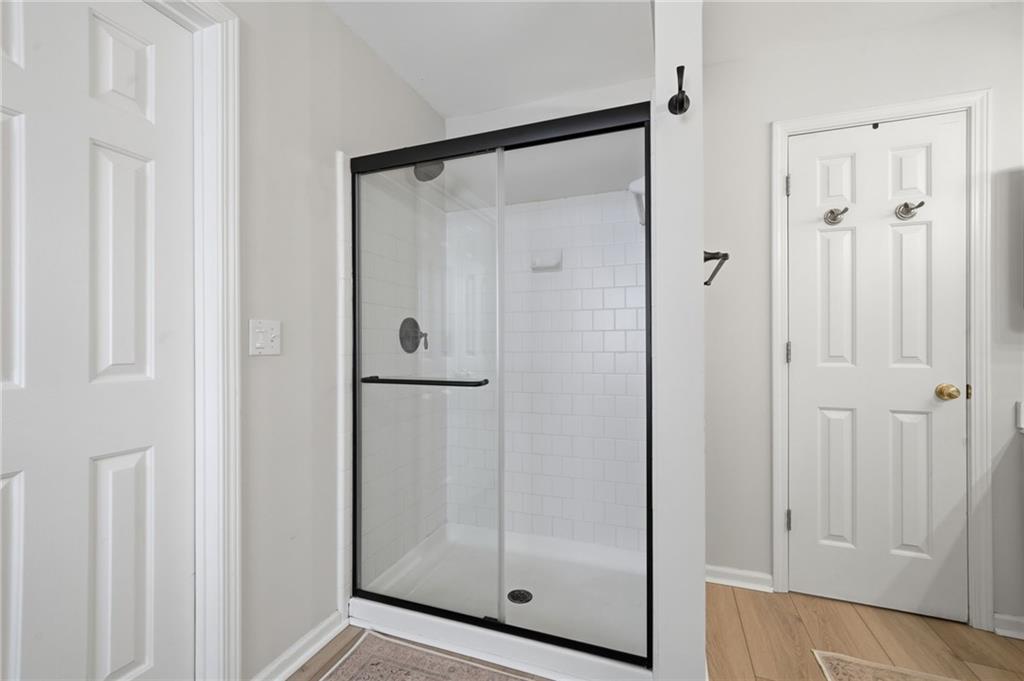 2135 Sugar Maple Lane Northwest Acworth, GA 30101 - Photo 36 of 59 a bathroom with a glass shower door