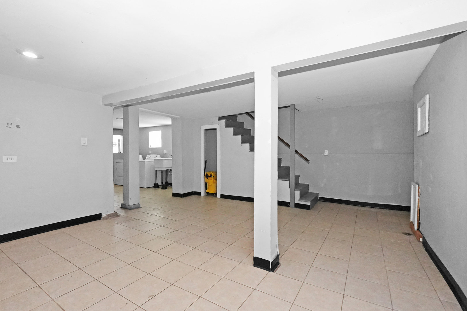 6409 South Champlain Avenue Chicago, IL 60637 - Photo 22 of 33 a view of a livingroom with wooden floor and stairs