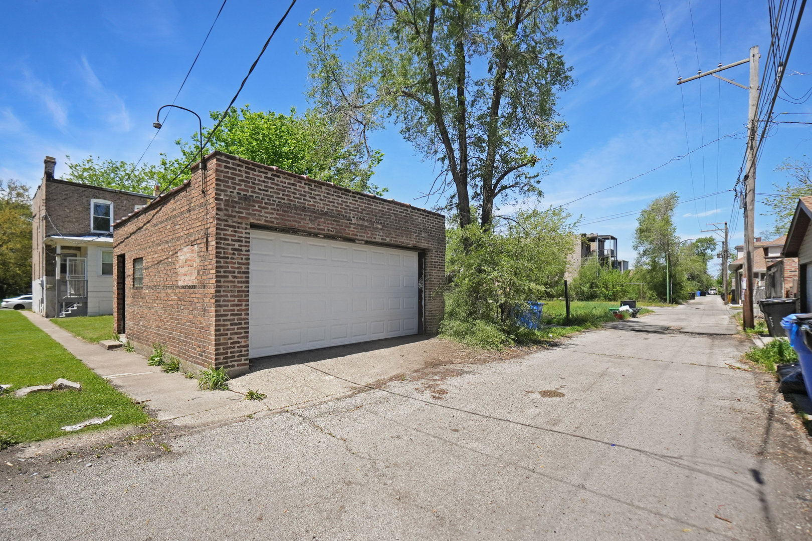 6409 South Champlain Avenue Chicago, IL 60637 - Photo 29 of 33 a front view of a house with a yard and garage