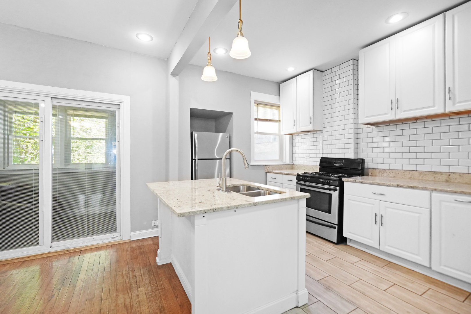 6409 South Champlain Avenue Chicago, IL 60637 - Photo 7 of 33 a kitchen with stainless steel appliances granite countertop a sink stove and refrigerator