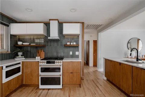 a kitchen with wooden floors and appliances