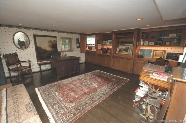 a living room with furniture and a dining table