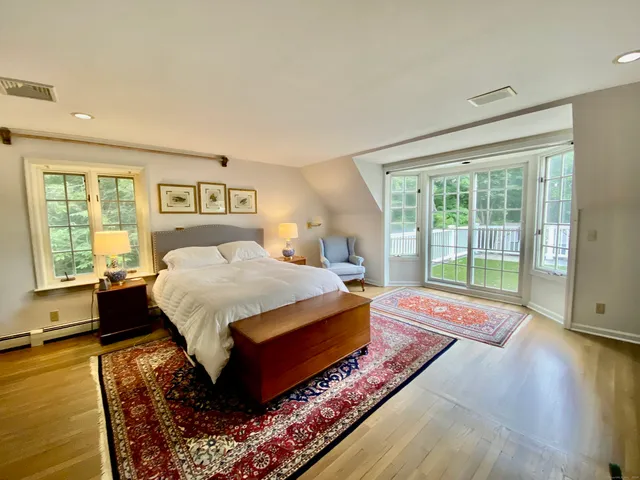 a spacious bedroom with a large bed and a window