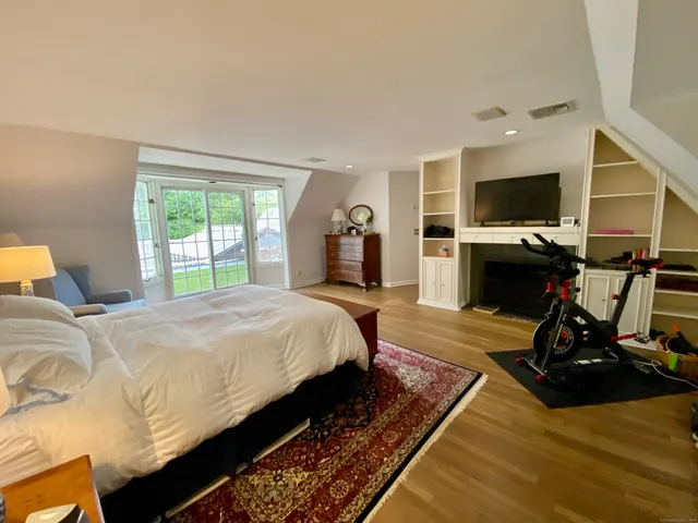 a bed room with a bed and a flat screen tv