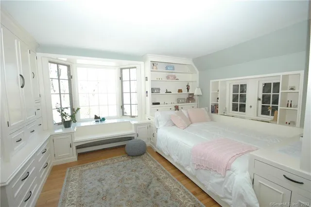 a spacious bedroom with a bed and a large window