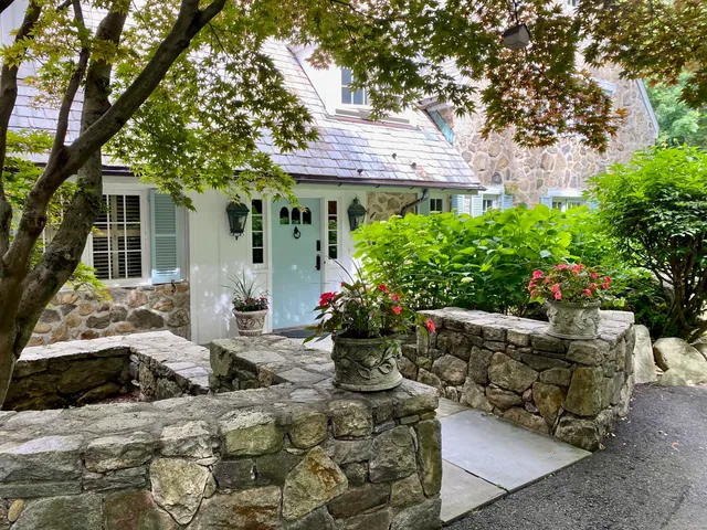 a front view of a house with a garden
