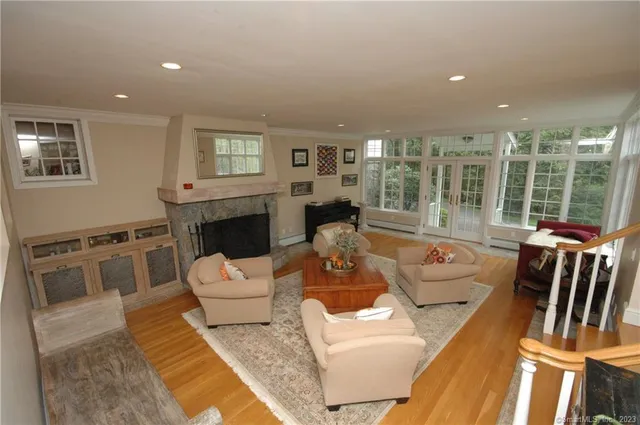 a living room with furniture fireplace and a table