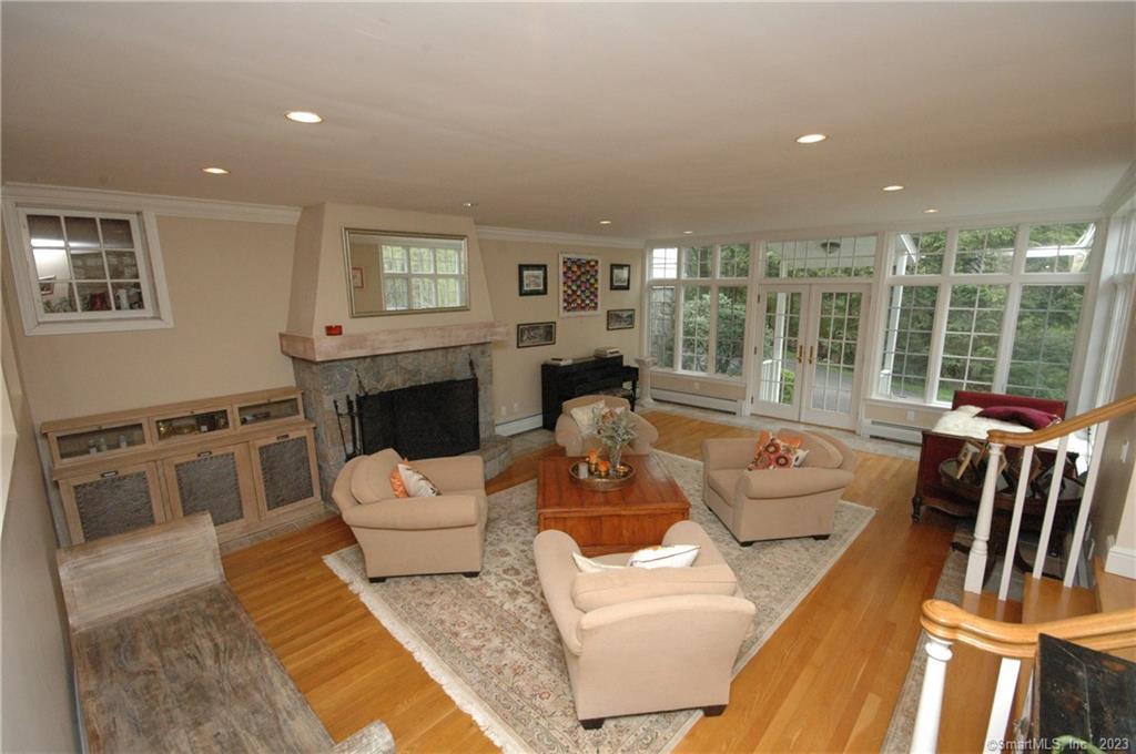 178 Ferris Hill Road New Canaan, CT 06840 - Photo 8 of 19 a living room with furniture fireplace and a table
