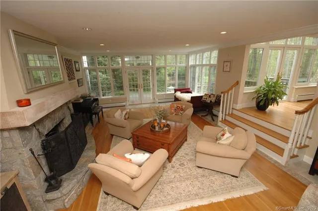 a living room with furniture and a floor to ceiling window