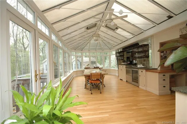 a very nice looking room with a large window and furniture