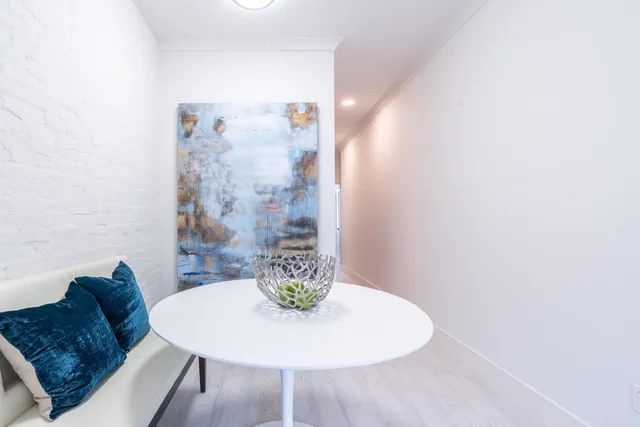 a dining room with furniture and wooden floor