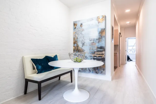 a view of a room with furniture and wooden floor