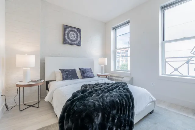 a bedroom with bed and window