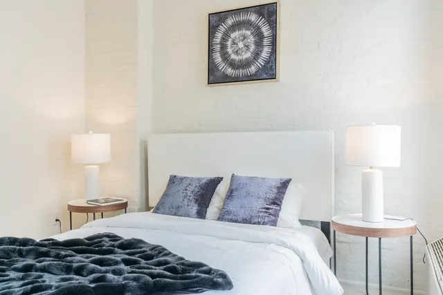 a bedroom with a bed and a lamp