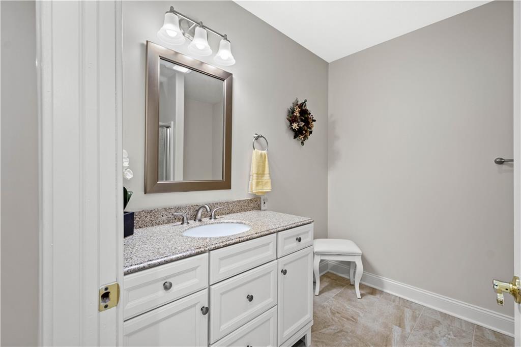 247 Whetherburn Drive Wexford, PA 15090 - Photo 20 of 25 a bathroom with a granite countertop sink and a mirror