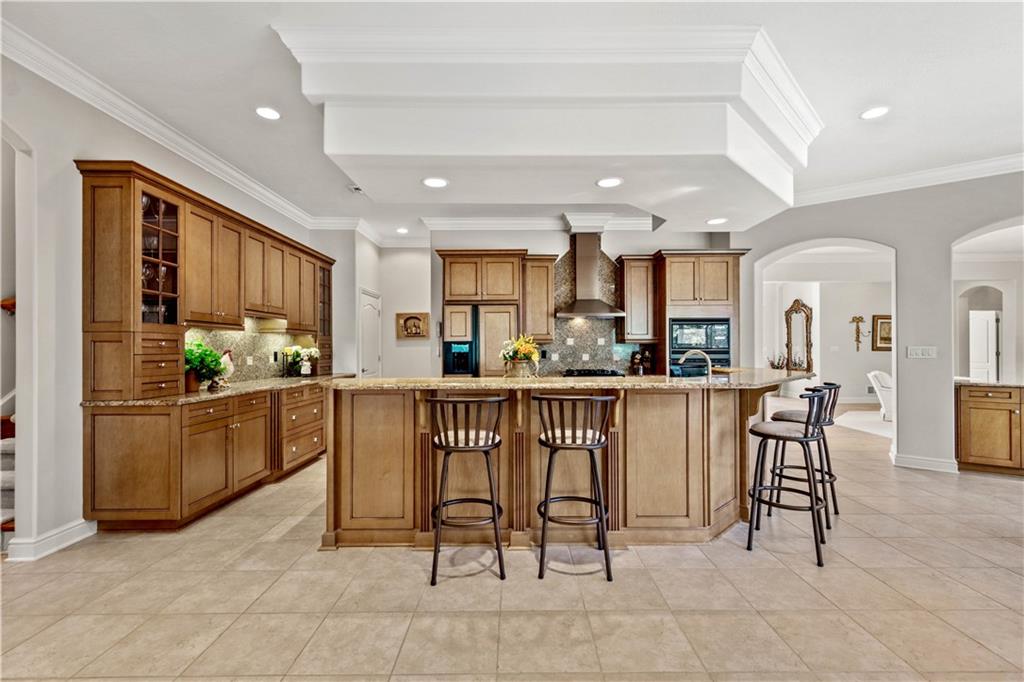 247 Whetherburn Drive Wexford, PA 15090 - Photo 8 of 25 a kitchen with stainless steel appliances kitchen island granite countertop a table and chairs in it