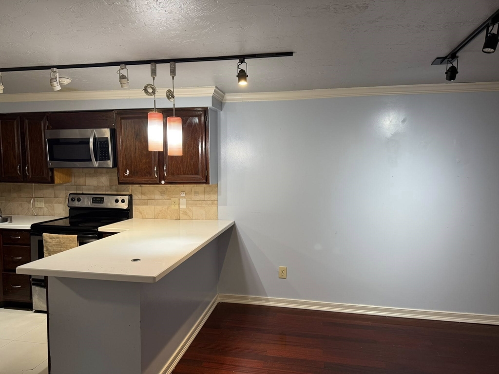 11 Hulbert Road, Unit 15 Worcester, MA 01603 - Photo 9 of 9 a kitchen with a sink a microwave and cabinets