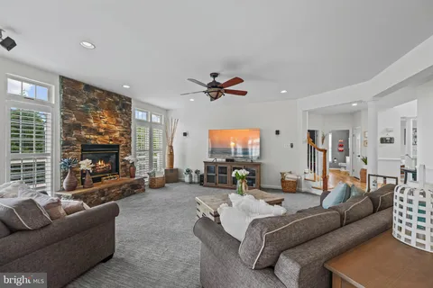 a living room with furniture and view of kitchen